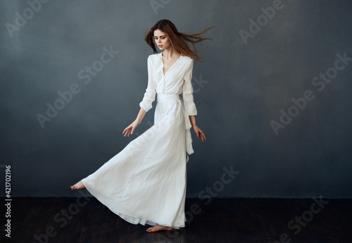 Woman in white dress dance performance luxury glamor gray background