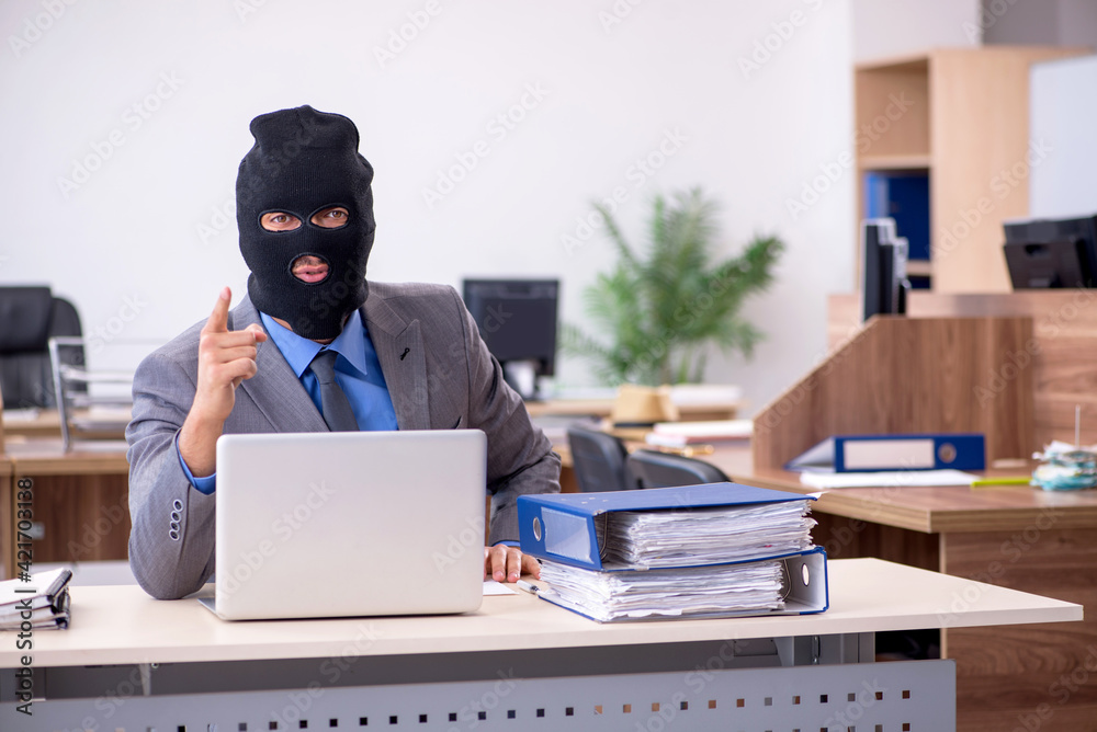 Young male employee in industrial espionage concept Young male employee in industrial espionage concept