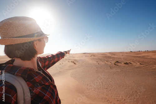 attractive asian young woman in plaid shirt in desert