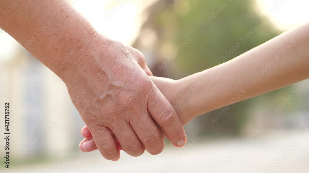 Close-up of hands joining together with sunlight Close-up of hands joining together with sunlight