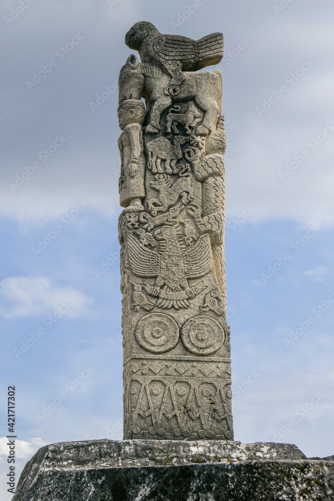 Traditional stone carving with bird, horse, deer, crocodile, camel and human on village megalithic tomb in Pau Rende, Sumba island, East Nusa Tenggara, Indonesia