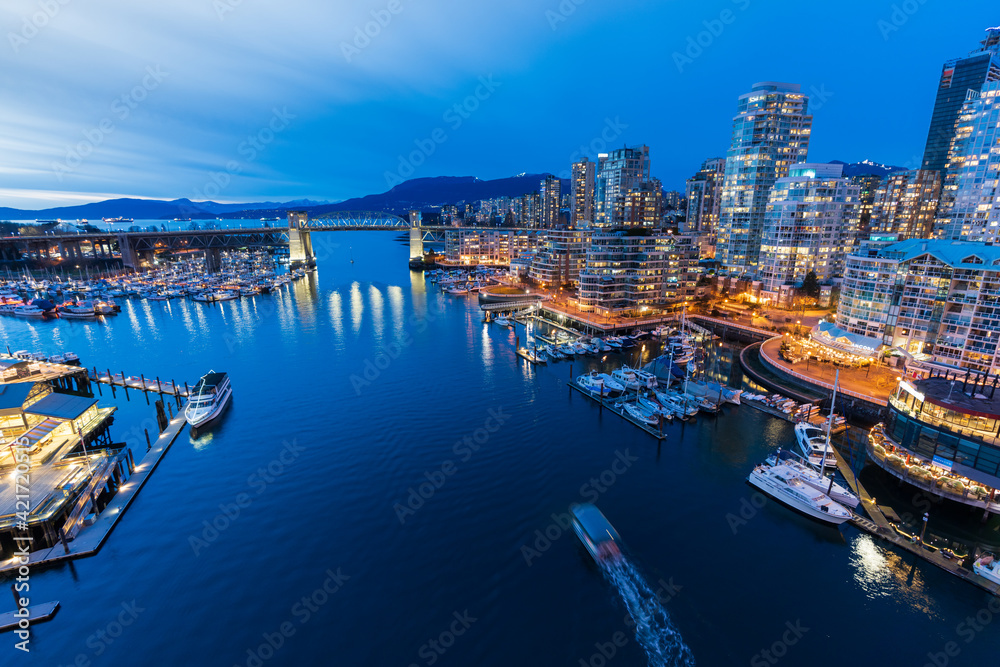 Beautiful view of Vancouver downtown skyline at sunset time, False Creek Harbour, British Columbia, Canada.