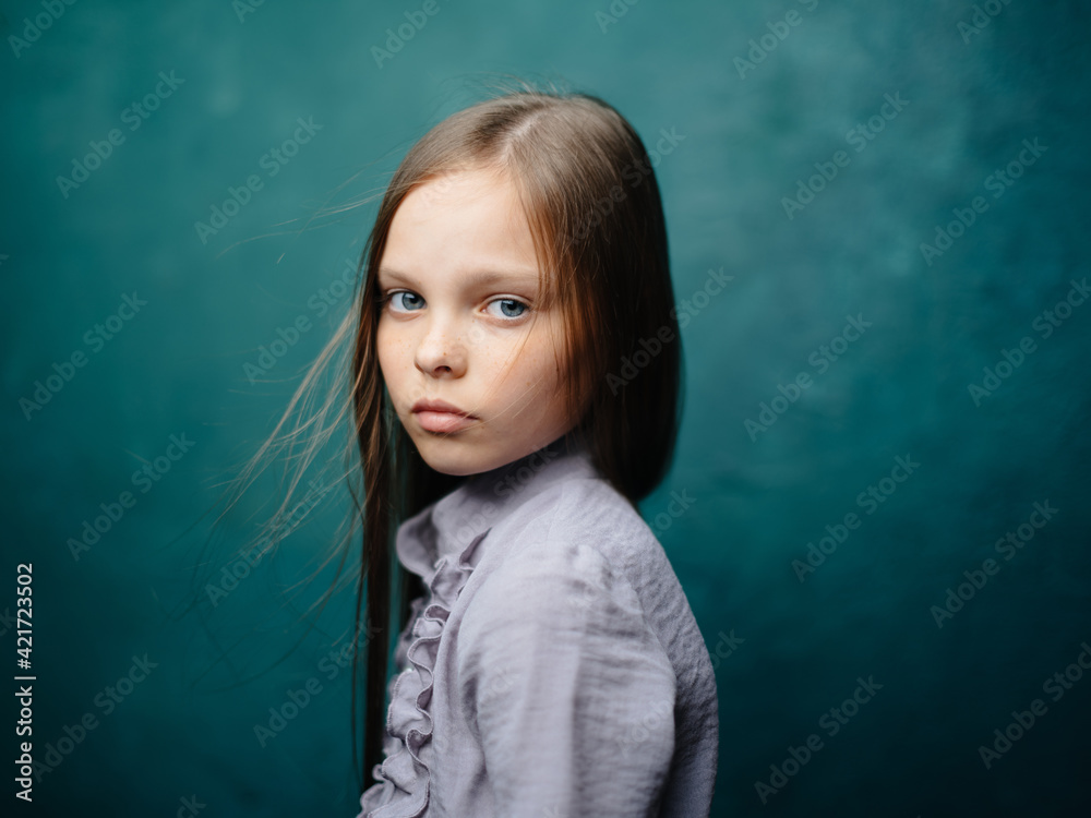 Beautiful girl on a turquoise background in a sundress close-up cropped view model portrait Beautiful girl on a turquoise background in a sundress close-up cropped view model portrait