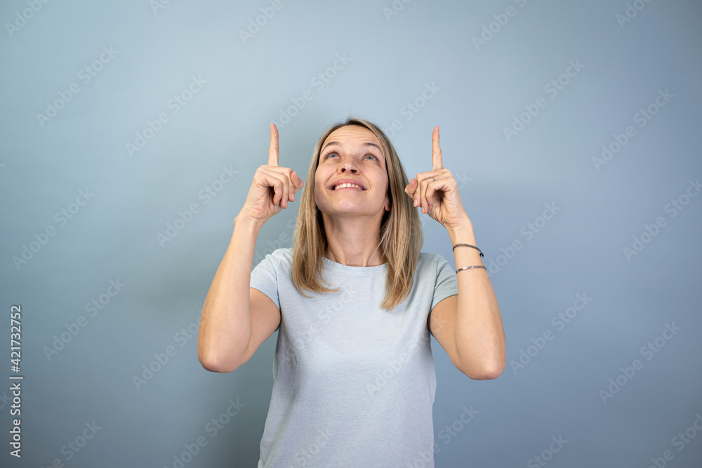 Fototapeta premium pretty young blond attractive woman posing on blue background doing different things in studio