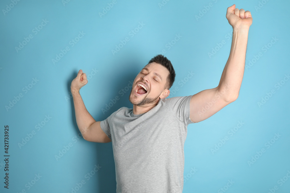 Portrait of sleepy man yawning on turquoise background Portrait of sleepy man yawning on turquoise background