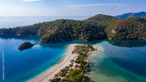 Panoramic and vivid shot of Oludeniz, also known as Blue Lagoon, in Fethiye. It is located on south-west of Turkey and it has been a tourist attraction with its blue sea, weather and coast.