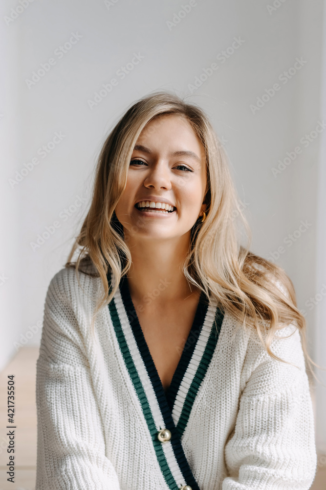 Emotional portrait of a young blonde woman laughing, looking at camera. Emotional portrait of a young blonde woman laughing, looking at camera.