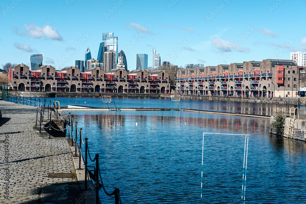 Shadwell basin, London, in a beautiful spring morning. City buildings on the background.