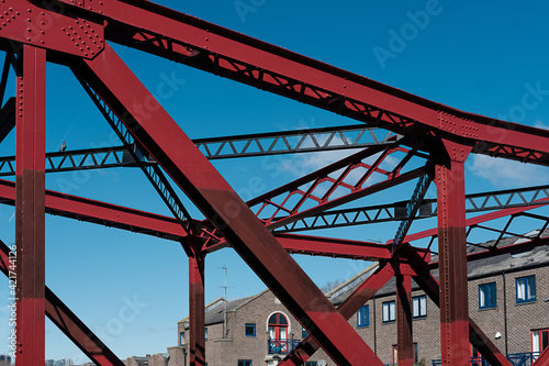 Red bascule bridge over Shadwell basin in a beautiful spring morning. Abstract graphic structure. photo