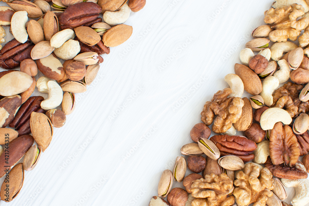 Organic mixed nuts banner with place for text. Assorted nuts: hazelnuts walnuts, pecans, pistachio, almonds, cashews. Healthy food, useful microelements and vitamins. Useful health snack Organic mixed nuts banner with place for text. Assorted nuts: hazelnuts walnuts, pecans, pistachio, almonds, cashews. Healthy food, useful microelements and vitamins. Useful health snack