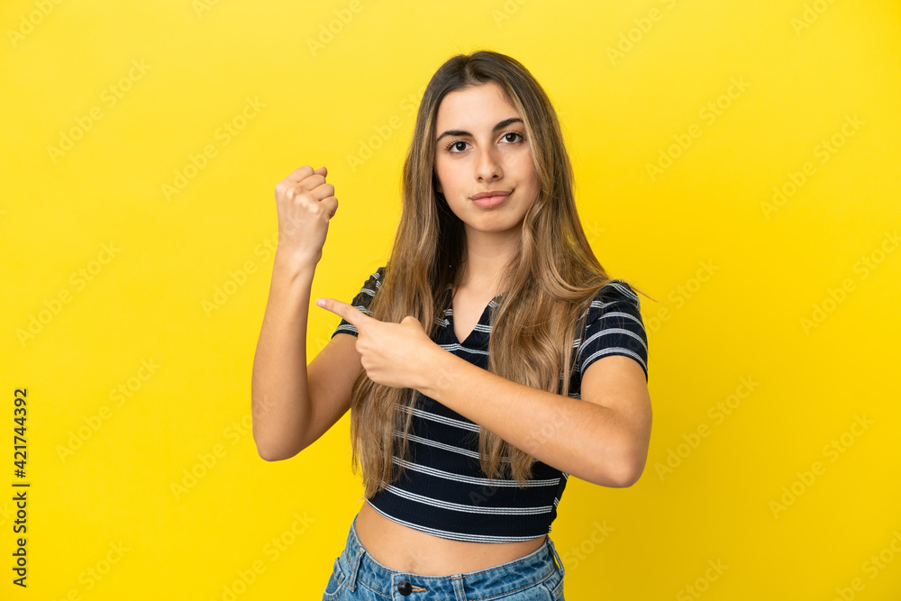 Young caucasian woman isolated on yellow background making the gesture of being late Young caucasian woman isolated on yellow background making the gesture of being late