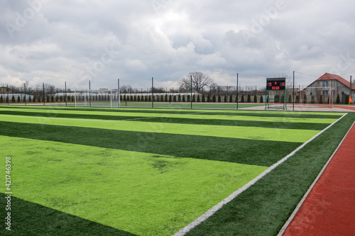 Artificial green grass on a professional soccer field. Outdoor artificial soccer field awaiting players' exit