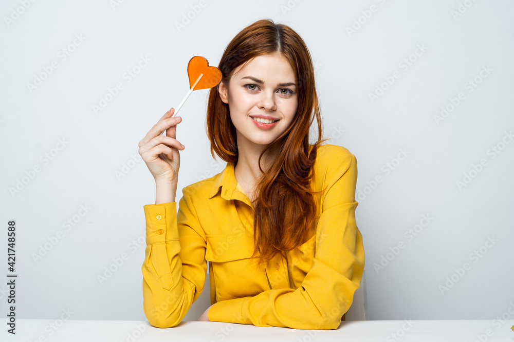 woman in yellow shirt lollipop heart charm lifestyle woman in yellow shirt lollipop heart charm lifestyle