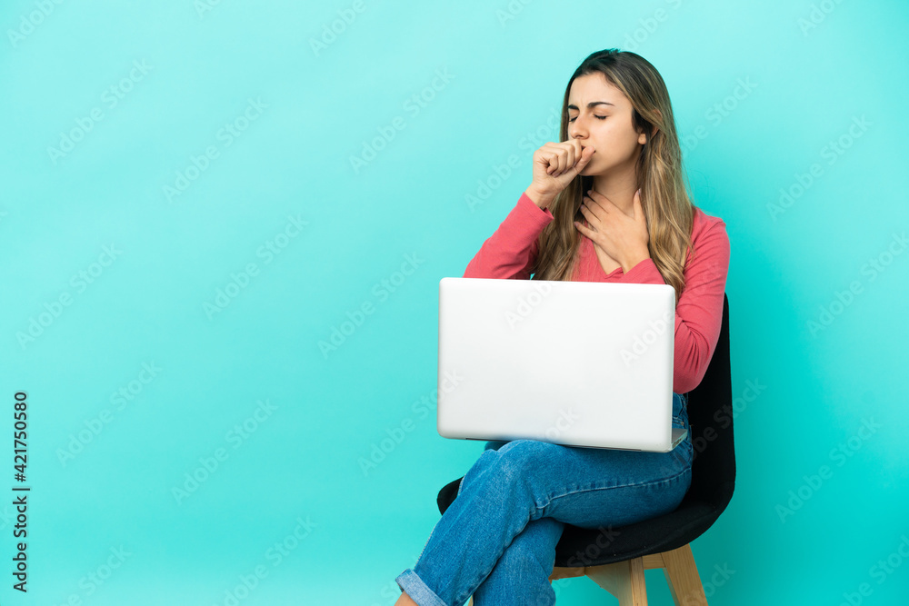 Young caucasian woman sitting on a chair with her pc isolated on blue background is suffering with cough and feeling bad Young caucasian woman sitting on a chair with her pc isolated on blue background is suffering with cough and feeling bad