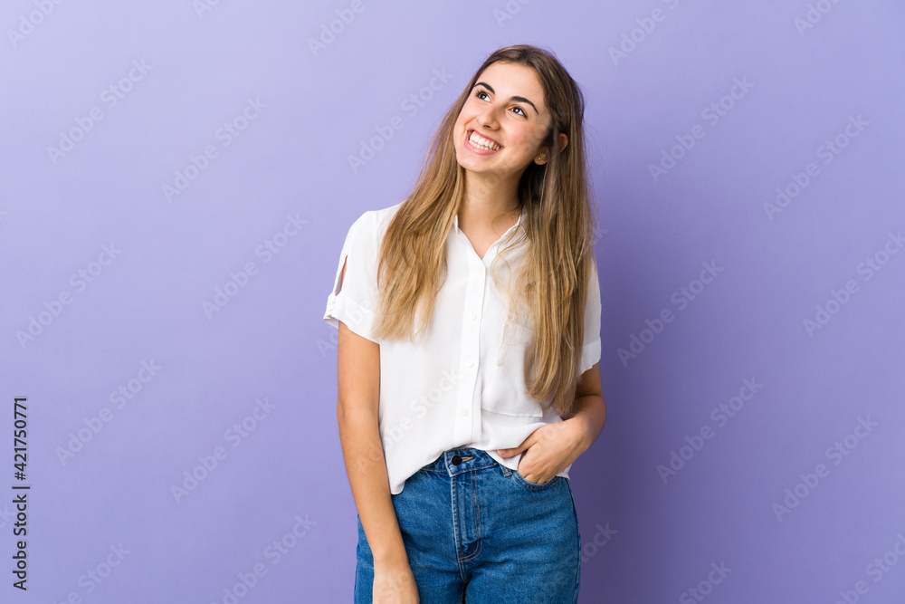 Young woman over isolated purple background thinking an idea while looking up Young woman over isolated purple background thinking an idea while looking up