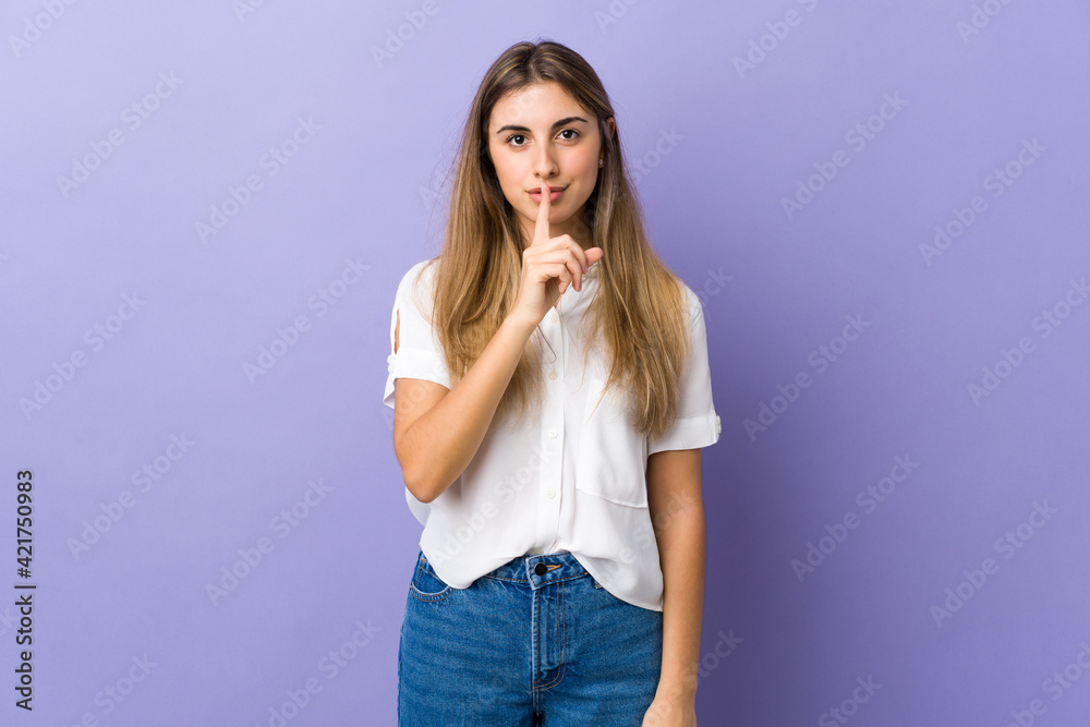 Young woman over isolated purple background showing a sign of silence gesture putting finger in mouth Young woman over isolated purple background showing a sign of silence gesture putting finger in mouth