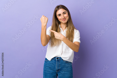 Young woman over isolated purple background making the gesture of being late