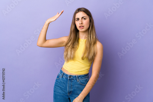 Young woman over isolated purple background with tired and sick expression