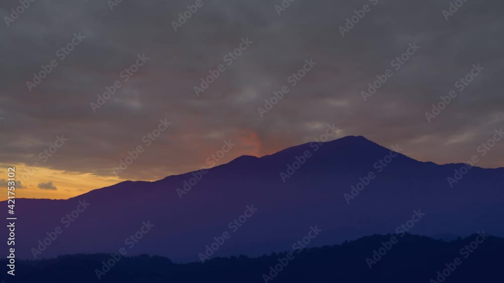 blue mountain silhouette under a dense cloudy sky, natural mountain time lapse scene blue mountain silhouette under a dense cloudy sky, natural mountain time lapse scene