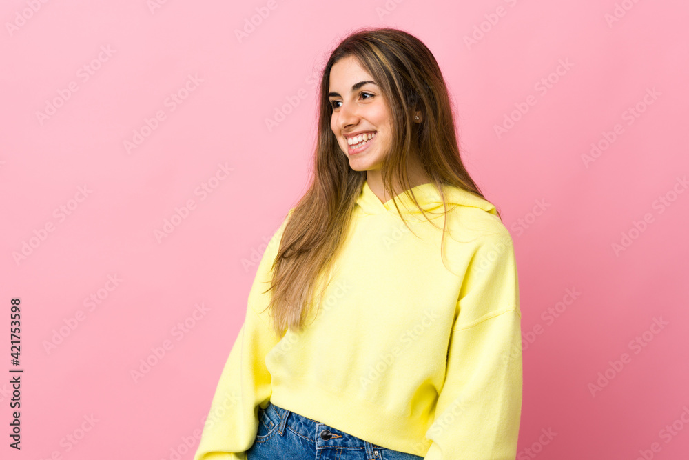 Young woman over isolated pink background looking side Young woman over isolated pink background looking side