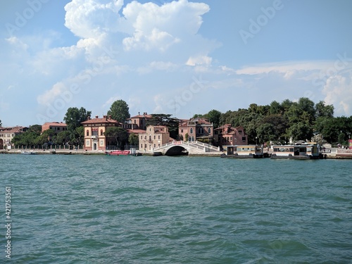 View of an ancient bridge near venice from the sea during summer vacation in italy