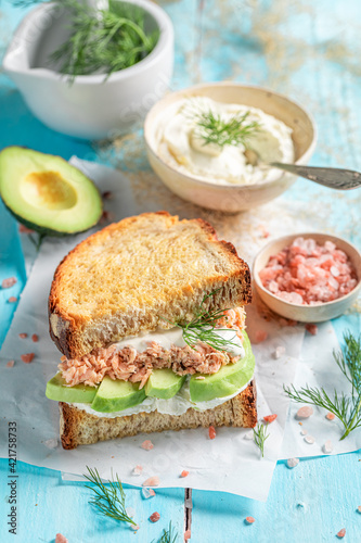 Homemade sandwich with salmon and avocado for fresh lunch.