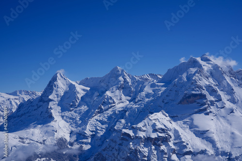 Panorama of Bernese Alps with Mountain Peaks Eiger  M  nch  monk  and Jungfrau  virgin   seen from M  rren  Switzerland.