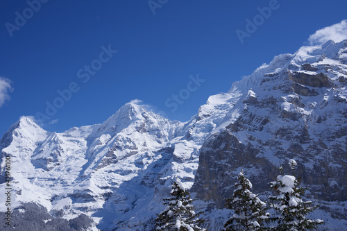 Panorama of Bernese Alps with Mountain Peaks Eiger  M  nch  monk  and Jungfrau  virgin   seen from M  rren  Switzerland.