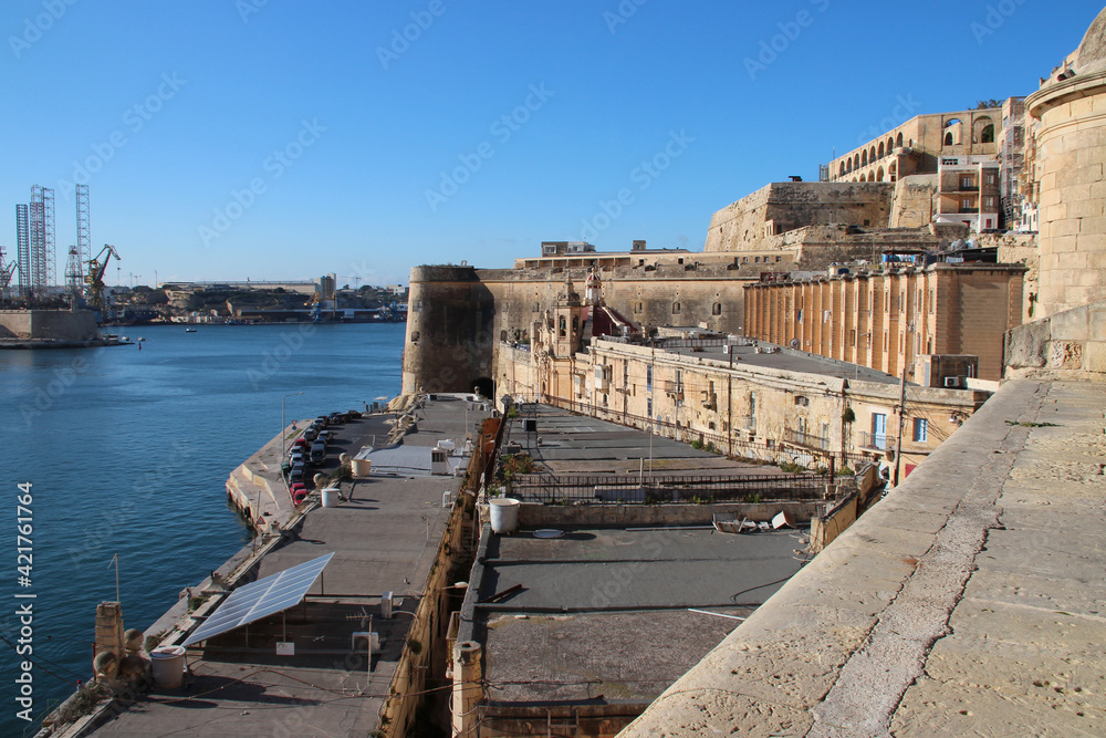 buildings, quay and mediterranean sea in valletta in malta