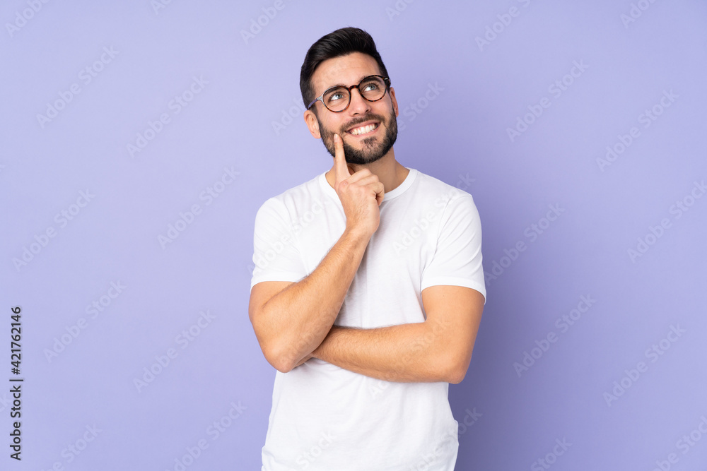 Caucasian handsome man over isolated background thinking an idea while looking up Caucasian handsome man over isolated background thinking an idea while looking up