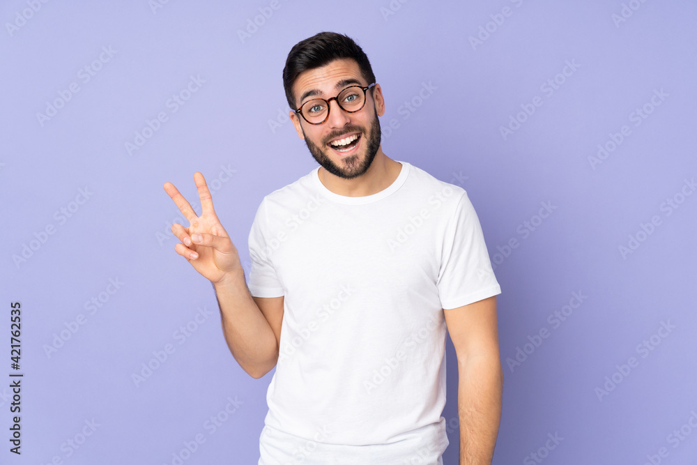 Caucasian handsome man over isolated background smiling and showing victory sign Caucasian handsome man over isolated background smiling and showing victory sign