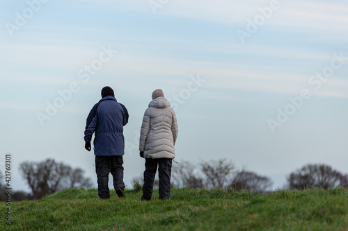A unknown couple taking a walk through the beautiful Suffolk countryside on a cold winters day