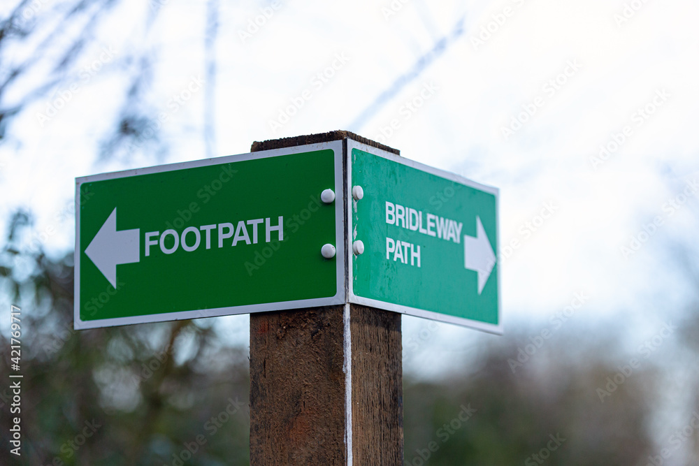Rural 2 way signpost showing a footpath and a bridal way. Countryside, directions, lost concept Rural 2 way signpost showing a footpath and a bridal way. Countryside, directions, lost concept