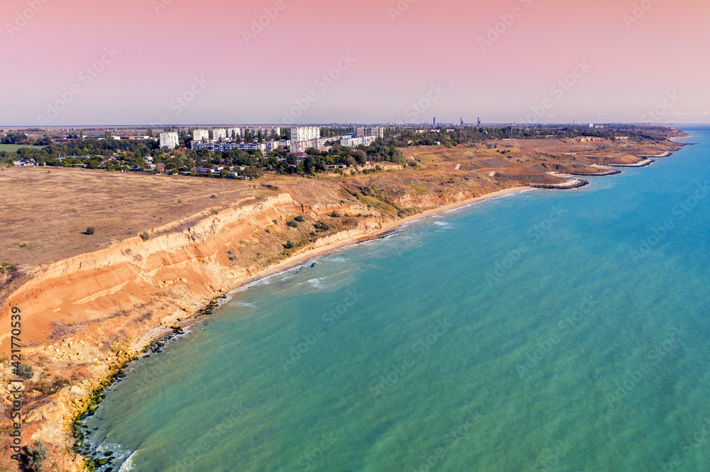 Seascape with sea and city on the clay steep coast. Aerial view of Chornomorske, Odesa, Ukraine