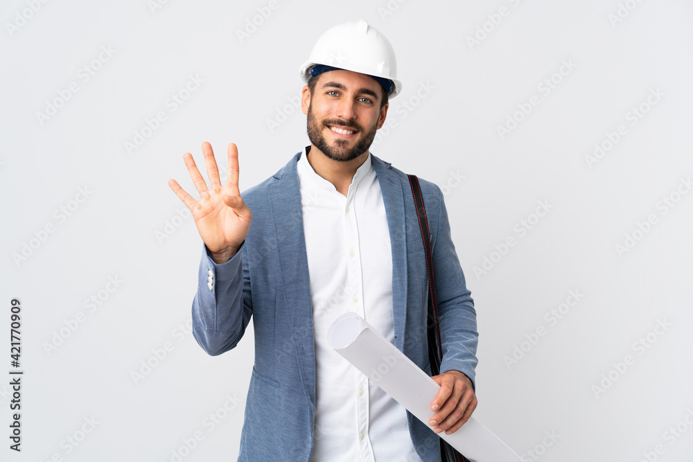 Young architect man with helmet and holding blueprints isolated on white background happy and counting four with fingers