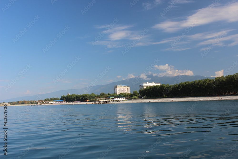 Small marina, beach, hotel and mountains