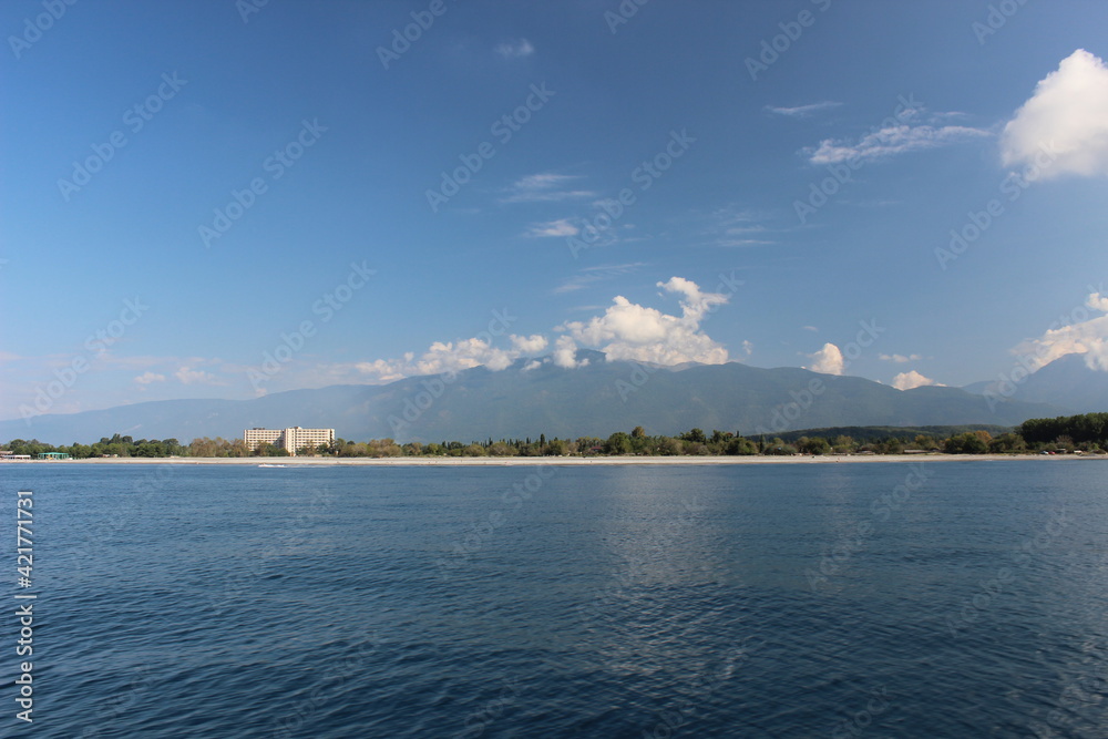 Deserted sea beach, forest and mountains
