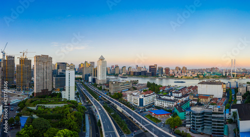 Aerial view of modern city skyline and buildings at dusk in Shanghai. © ABCDstock