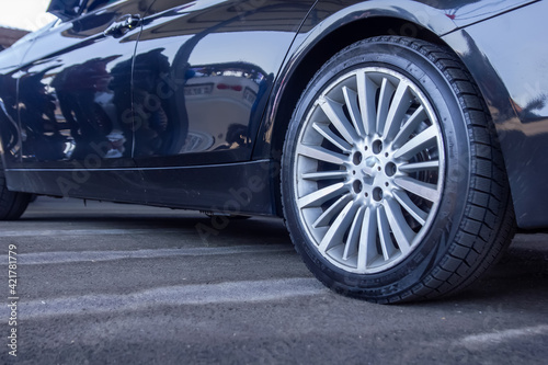 car on the road, car wheel on the road, close up of a sports car wheel