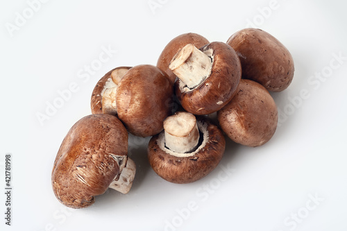 Fresh mushrooms on white. Brown champignons. A bunch of mushrooms.