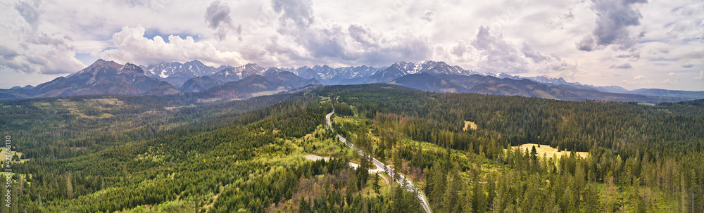 Spring rainy weather mountain panorama. Green forest hills. Road from Poland to Slovakia
