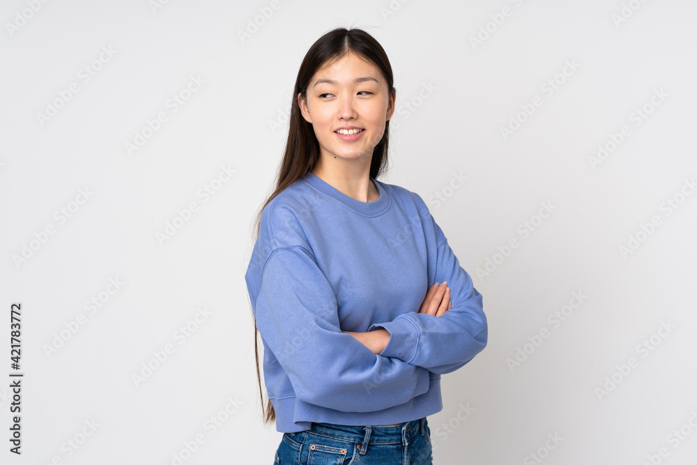Young asian woman isolated on background with arms crossed and happy Young asian woman isolated on background with arms crossed and happy