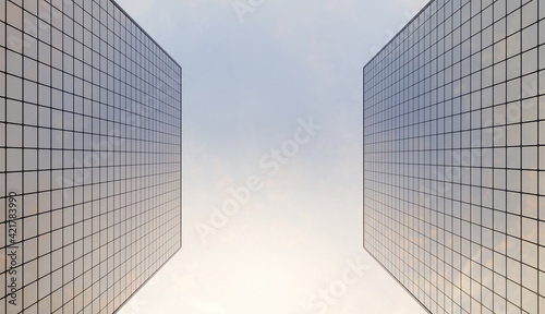 glass skyscraper seen from below with a cloudy sky