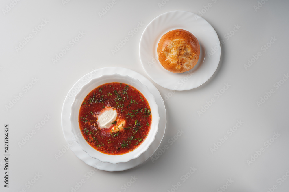 Borscht with sour cream in a white plate top view Borscht with sour cream in a white plate top view