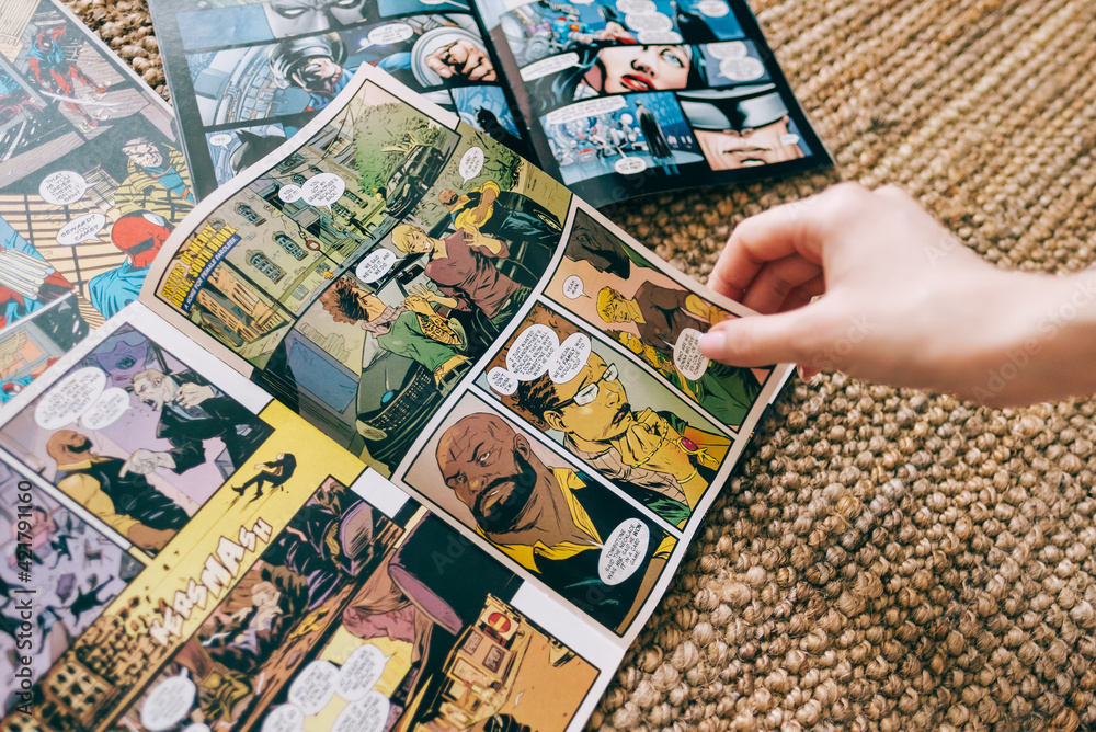 Naklejka premium Woman reads manga comic book on the carpet at home. Rostov-on-Don, Russia. 18 March 2021