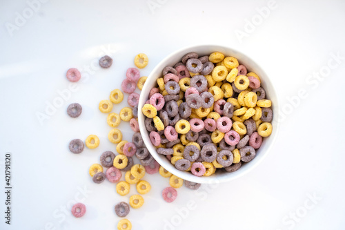 Colored flakes in a plate and sprinkled on a white background