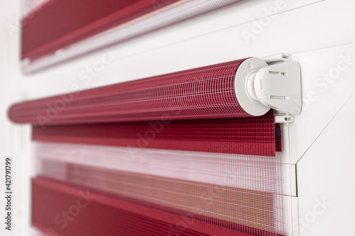 Fotografie Color fabric roller blind on the top of the window