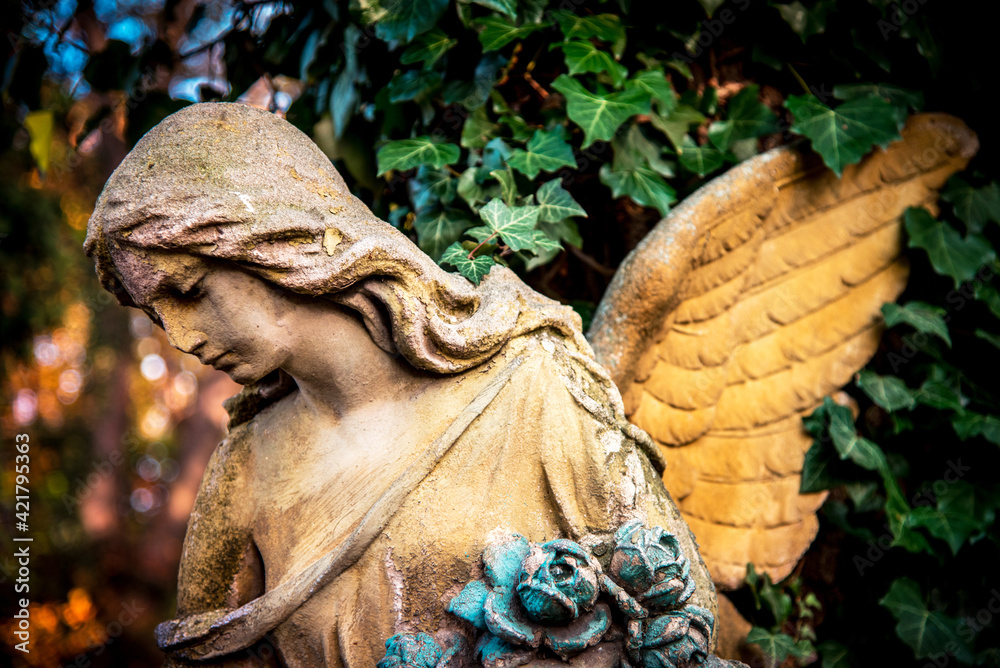 A fragment of ancient sculpture angel in the old cemetery. Symbol of love, invisible forces, purity, enlightenment, ministry, salvation. Chariot.