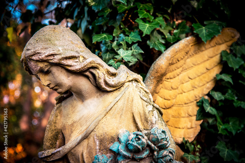 A fragment of ancient sculpture angel in the old cemetery. Symbol of love, invisible forces, purity, enlightenment, ministry, salvation. Chariot.