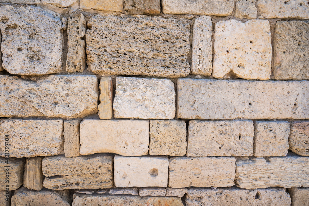 Fototapeta premium Red laterite stone wall texture background